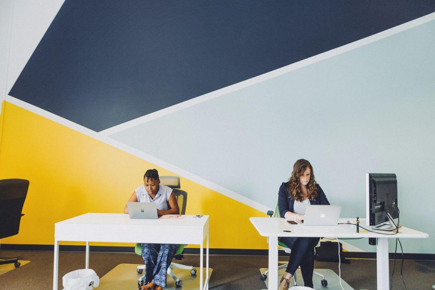 Students collaborating on financial analysis projects in modern learning environment